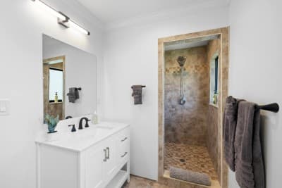 Spacious and stylish, the second full bathroom features a large walk-in shower and modern finishes—perfect for relaxing after a day in the sun.